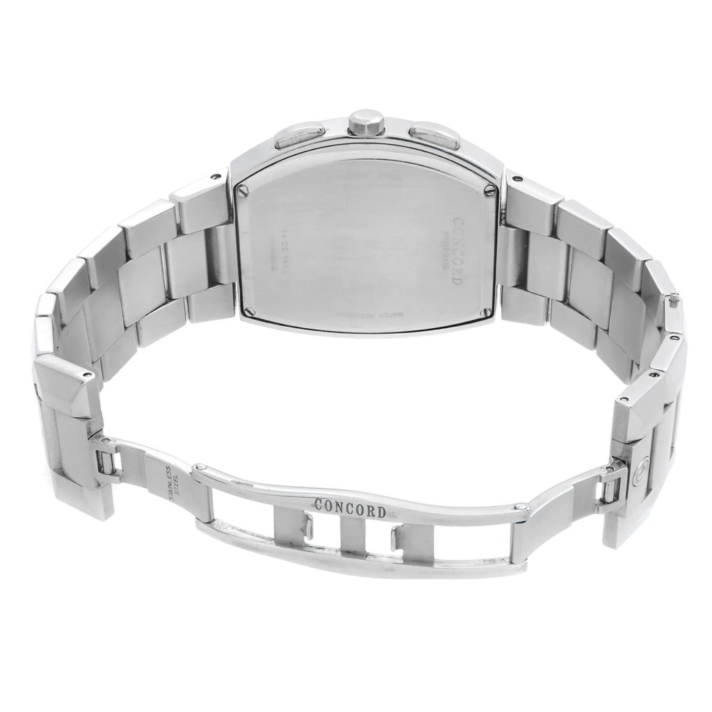 An image of a pre-owned wristwatch viewed from the back, showing an open clasp. The watch is positioned at a slight angle, capturing the metallic bracelet and the back of the watch face. The brand name is visible on the clasp. The image is taken from a close distance, highlighting the details of the watch's construction and finish.