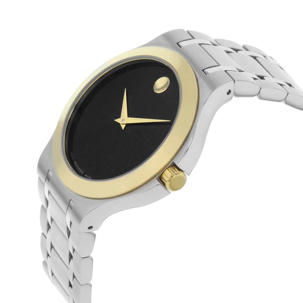 An image of a pre-owned wristwatch, shown in a front close-up shot of the watch face. The watch features a minimalist black dial with two gold hands and a gold dot at the 12 o'clock position. It has a gold bezel and a stainless steel band, with the crown positioned on the right side. The angle captures the watch from a slightly elevated perspective, emphasizing its sleek design.