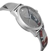 An image of an unworn Gucci wristwatch for unisex adults, showcasing a side profile view from the side opposite the crown. The watch features a round stainless steel case with a casual style, and a silver dial adorned with an animal print pattern. The stainless steel band displays a portion of the same animal print, visible on the lower half of the band. The watch is captured from a close distance, emphasizing the dial and the side contour of the watch.