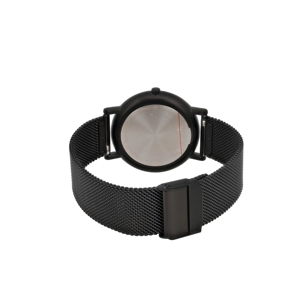 An image of a Skagen women's wristwatch displayed from the back, showcasing the circular stainless steel case and black mesh band. The watch is positioned upright, providing a clear view of the rear side, with the strap slightly open. The angle is direct and slightly elevated, capturing the details of the clasp and the case back from a close distance.