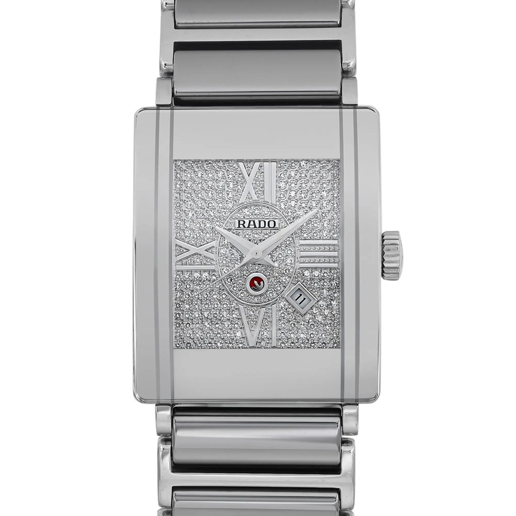 An image of a pre-owned Rado men's wristwatch with a front close-up shot of the watch face. The watch has a casual style with a rectangular shape and is constructed from ceramic and stainless steel materials. The dial is silver with a diamond pattern and Roman numerals as hour marks. The bezel is also silver and shows a hairline scratch. The band is made of a combination of ceramic and stainless steel. The watch exhibits minor signs of wear or scratches and is considered to be in good condition. The indices include a 12-hour dial with non-numeric hour marks, and the watch is positioned at a straight angle with the camera at a close distance, providing a clear view of the details.