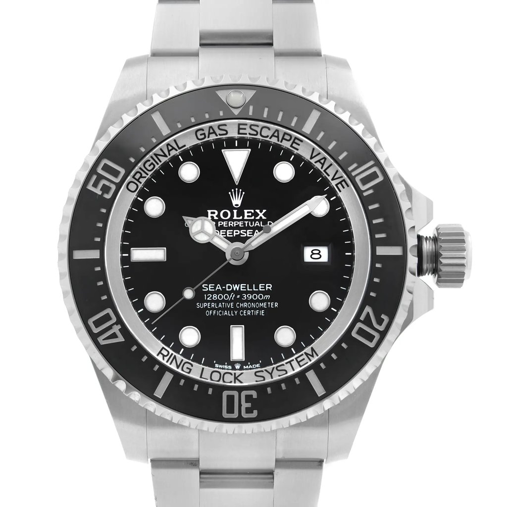 An image of a pre-owned wristwatch shown in a front close-up shot. The focus is on the watch face, displaying a black dial with white markers and a date window. The bezel is detailed with numerals and text, and the watch features a stainless steel bracelet. The angle is straight-on, capturing the intricate details of the timepiece.