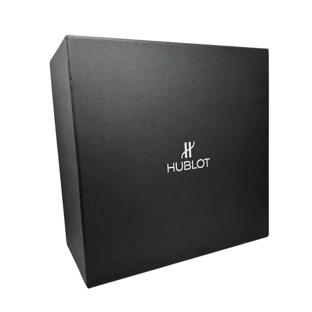 An image of a black Hublot wristwatch box, photographed from a slight side angle, showing the brand logo prominently on the front. The box is positioned upright against a plain white background, and the image is taken from a close distance to capture the texture and details of the box.