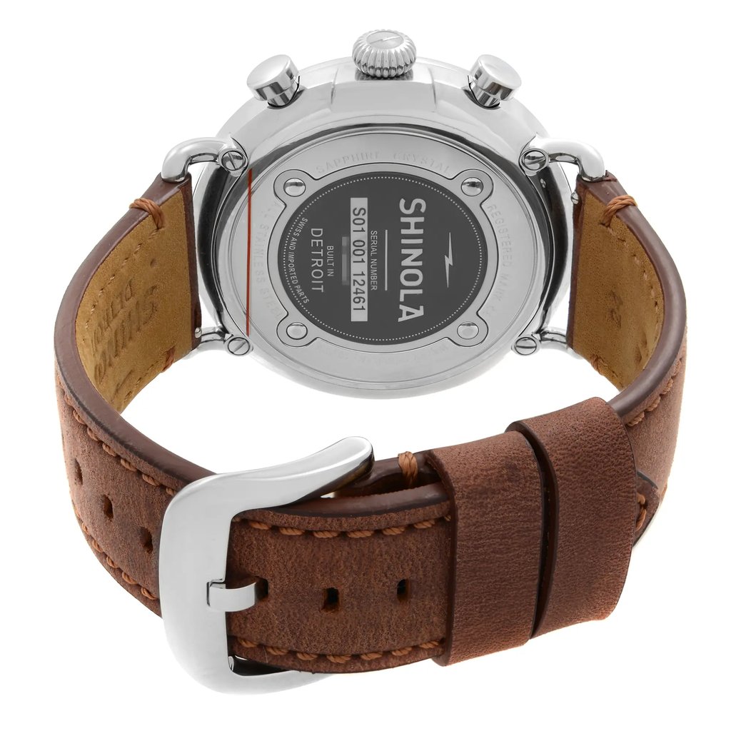 An image of a Wristwatch by Shinola. This Pre Owned item is designed for Men, featuring a Casual style. It has a Quartz movement and an Analog display with a Blue dial color. The indices include 12-Hour Dial,Arabic Numerals. The band is made of Stainless Steel and the case is made of Stainless Steel. The watch has a Round shape with a case size of 47 mm and a case thickness of 12 mm.