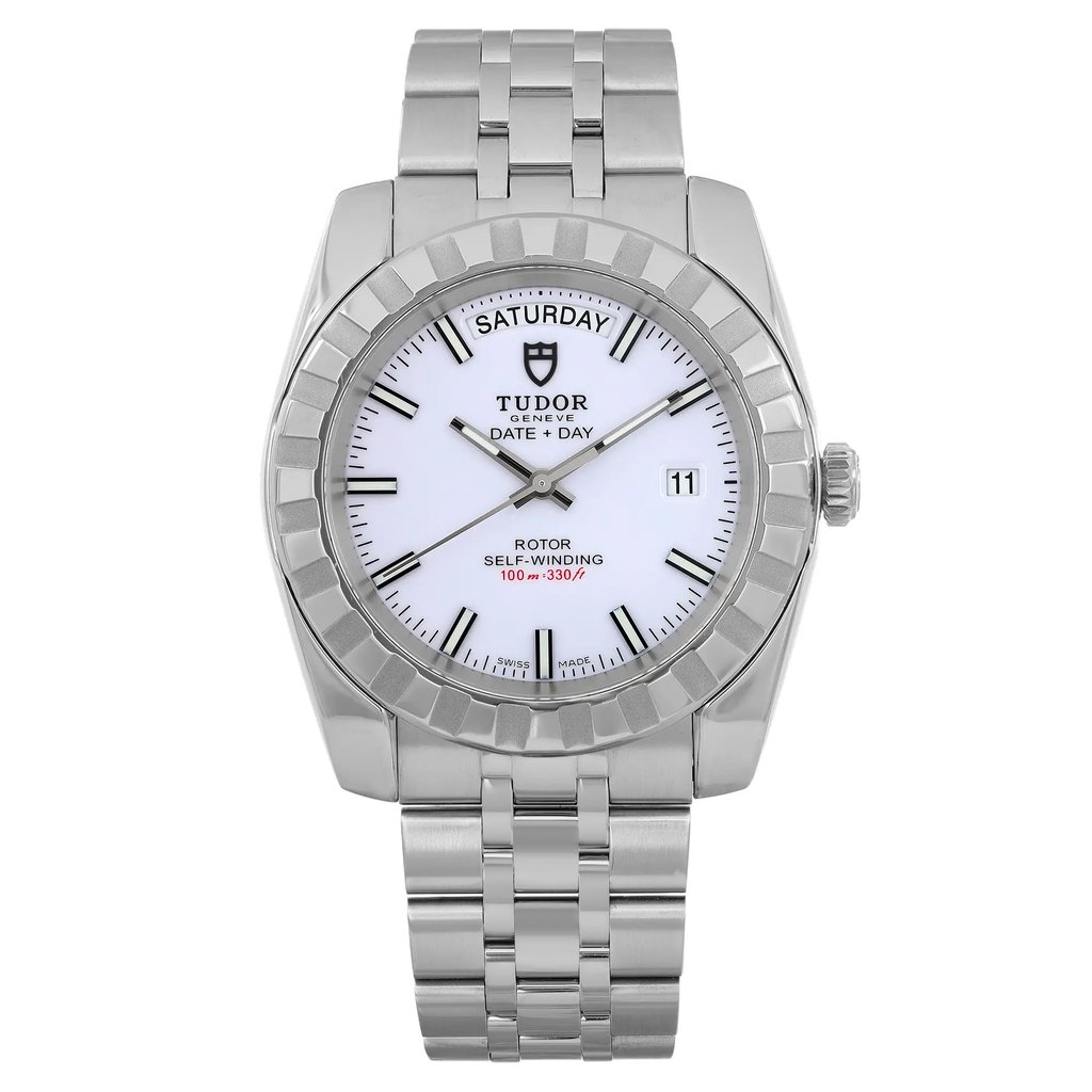 An image of a pre-owned men's TUDOR Classic Date-Day 41mm wristwatch, captured from a straight-on angle at a close distance. The watch features a stainless steel bracelet and case, with a white dial displaying day and date functions. The luminous hands and markers are clearly visible, emphasizing its elegant and functional design.