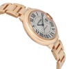 An image of a pre-owned wristwatch in a side profile view, opposite of the crown. The watch is positioned at a slight angle, showcasing its sleek, metallic bracelet and elegantly curved case. The distance is close enough to clearly display the watch face, which features Roman numerals and blue hands. The overall design appears sophisticated and luxurious.