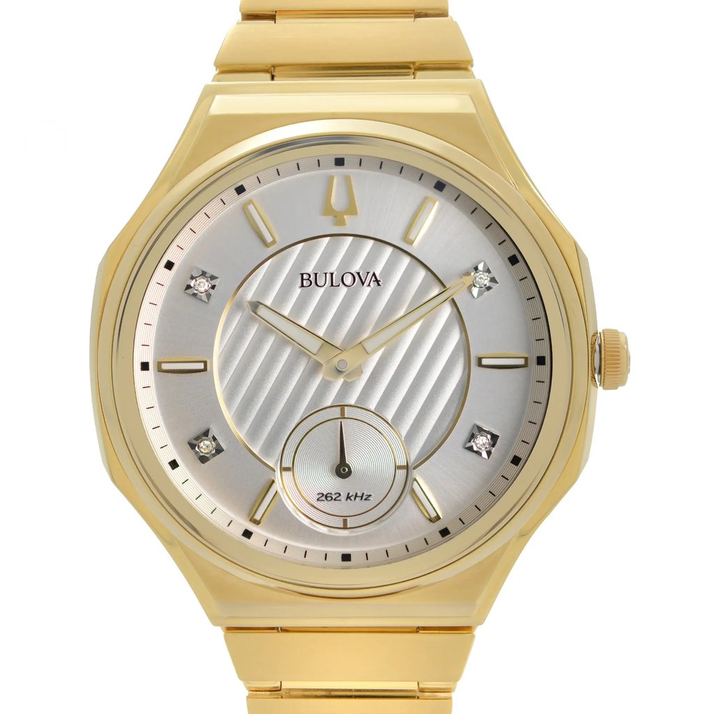 An image of a new Bulova women's dress/formal wristwatch, featuring a round stainless steel case and a gold-tone bezel. The watch is presented in a front close-up shot, with the watch face occupying most of the frame, providing a clear view of the silver dial, luminous hands, and non-numeric hour marks. The brand name "BULOVA" is visible on the dial, along with decorative gem indices and a small sub-dial marked "262 kHz." The stainless steel band material is partly visible, connecting to the top of the watch case at a straight angle from the perspective of the image.
