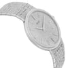 An image of a pre-owned Piaget unisex wristwatch. The watch is positioned at a slight angle, showing a close-up of the textured silver dial and bracelet. The watch face is tilted slightly to the right, highlighting the minimalist design with slender hour markers and hands. The image captures the watch from a close distance, emphasizing its detailed craftsmanship and elegant finish.