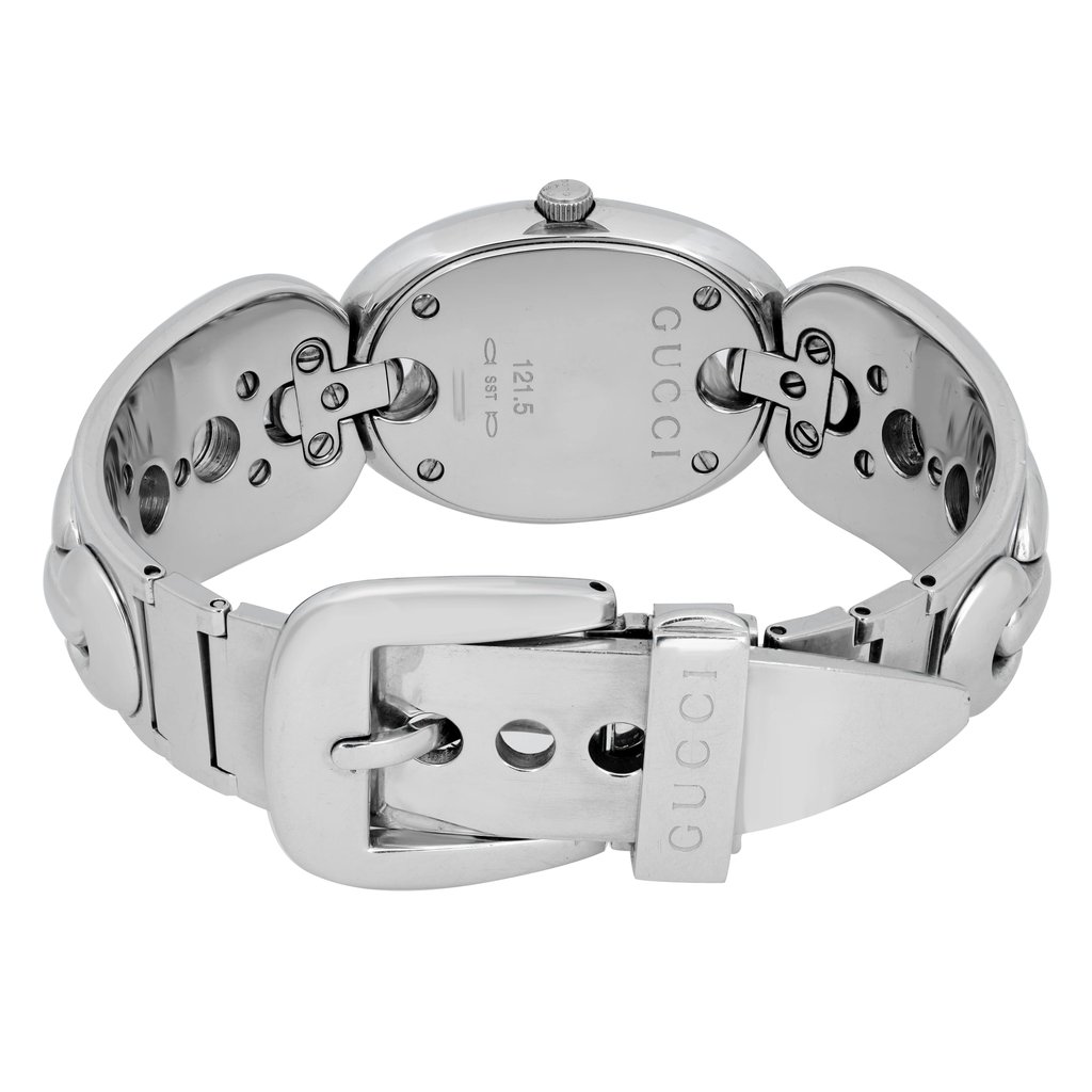 An image of a pre-owned Gucci women's wristwatch taken from the back, showcasing the stainless steel case and bracelet. The watch is positioned upright with the clasp and buckle in clear view, displaying the engraved brand name. The angle is slightly elevated, highlighting the watch's polished metal finish and intricate link design, captured at a close distance.