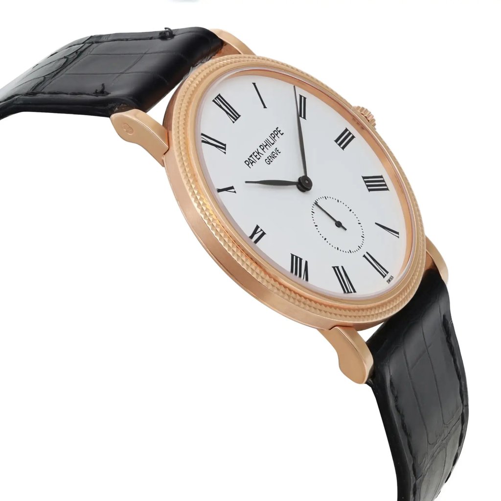 An image of a pre-owned wristwatch viewed from the side profile opposite the crown, showcasing its elegant design. The watch features a white dial with black Roman numerals and a sleek black leather strap. The rose gold case adds a touch of luxury. The angle highlights the thinness of the watch, captured from a close distance.