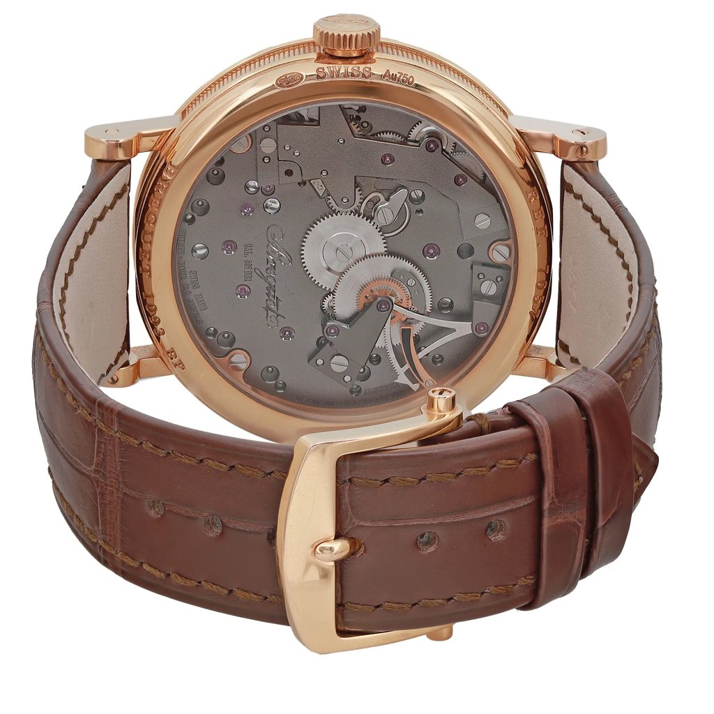An image of a pre-owned men's Breguet wristwatch taken from the back view, showcasing the exhibition caseback. The watch features a rose gold round case and a brown leather band with a buckle closure. The angle highlights the intricate mechanics within the case, emphasizing the power reserve indicator. The close-up perspective offers a clear view of the watch's detailed craftsmanship.