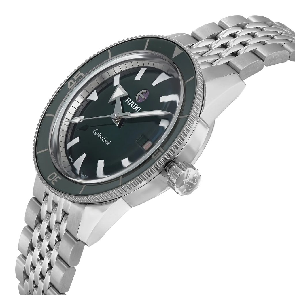 An image of an unworn men's wristwatch from Rado, shown from a side profile view highlighting the crown. The round watch features a green dial and bezel, with a stainless steel band and case. The watch is positioned at a slight angle, emphasizing its casual style and craftsmanship.