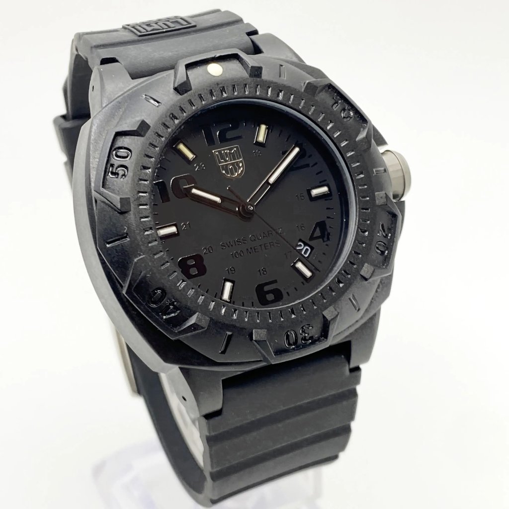 An image of a Wristwatch by Luminox. This Pre Owned item is designed for Men, featuring a Diver,Military style. It has a Quartz movement and an Analog display with a Black dial color. The indices include 12-Hour Dial,Arabic Numerals,Stick Indexes. The band is made of Rubber and the case is made of Carbon. The watch has a Round shape with a case size of 43 mm and a case thickness of 14 mm.