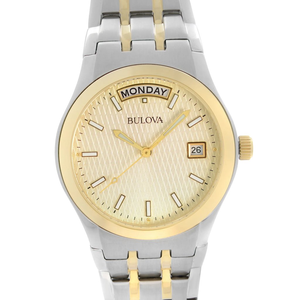 An image of a pre-owned Bulova men's wristwatch in good condition. The view is a front close-up shot of the watch face, positioned head-on. The round champagne dial features a diamond pattern, stick indexes, and luminous hands. A day/date window is visible at the three o'clock position. The bezel is gold-colored, and the band is made of stainless steel with gold accents. The watch has a casual style with a 12-hour dial.