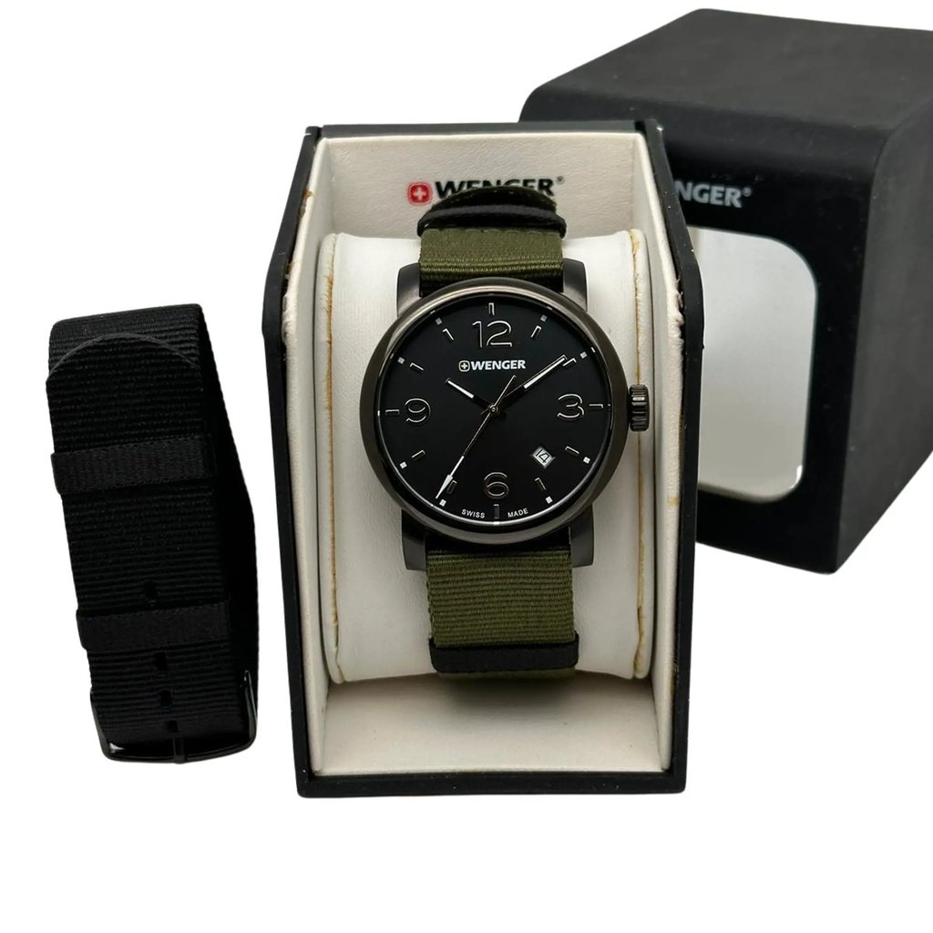 An image of a Wristwatch by Wenger. This Display Model item is designed for Men, featuring a Casual style. It has a Quartz movement and an Analog display with a Black dial color. The indices include 12-Hour Dial,Arabic Numerals. The band is made of Nylon and the case is made of Stainless Steel. The watch has a Round shape with a case size of 41 mm and a case thickness of 10 mm.