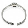An image of a pre-owned HERMÈS women's wristwatch positioned at a slight angle from the back, displaying the full length of the open metal bracelet. The watch face is tilted downward, showing the side profile of the watch case adorned with small diaminds. The watch is centered against a plain white background, allowing a clear view of its sleek and elegant design from a close distance.