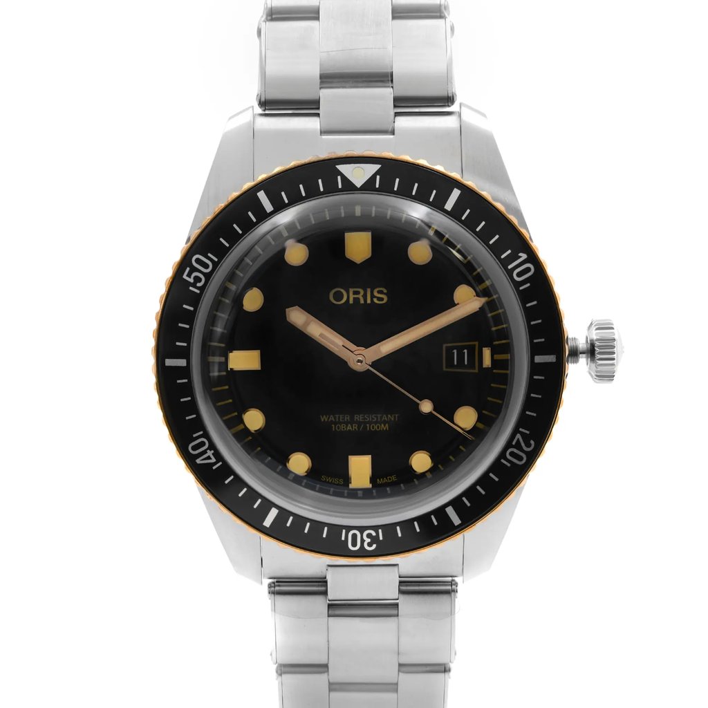 An image of a wristwatch taken from a front close-up angle, showcasing the watch face clearly. The watch features a black dial with gold hour markers and hands, a date display, and a rotating bezel. The silver metal bracelet is partially visible, and the watch is in display model condition.