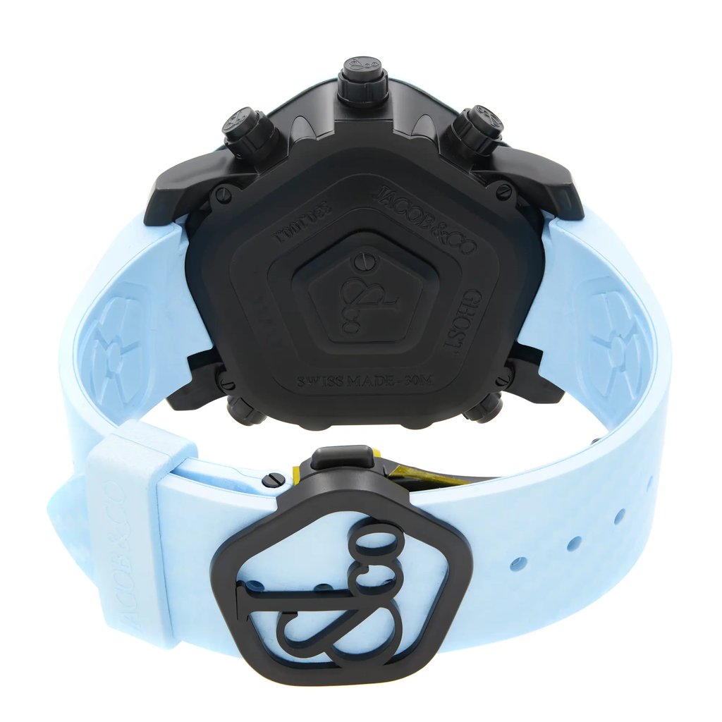An image of an unworn JACOB & Co. men's wristwatch, viewed from the back with a close clasp. The watch features a stainless steel pentagon-shaped case with a solid caseback, adorned with the brand's logo and inscriptions. It is equipped with a pale blue rubber band. The photo is taken from a top-down angle, giving a clear view of the watch's distinctive back and clasp design. The watch is centered in the frame, shown at a close distance to highlight details.