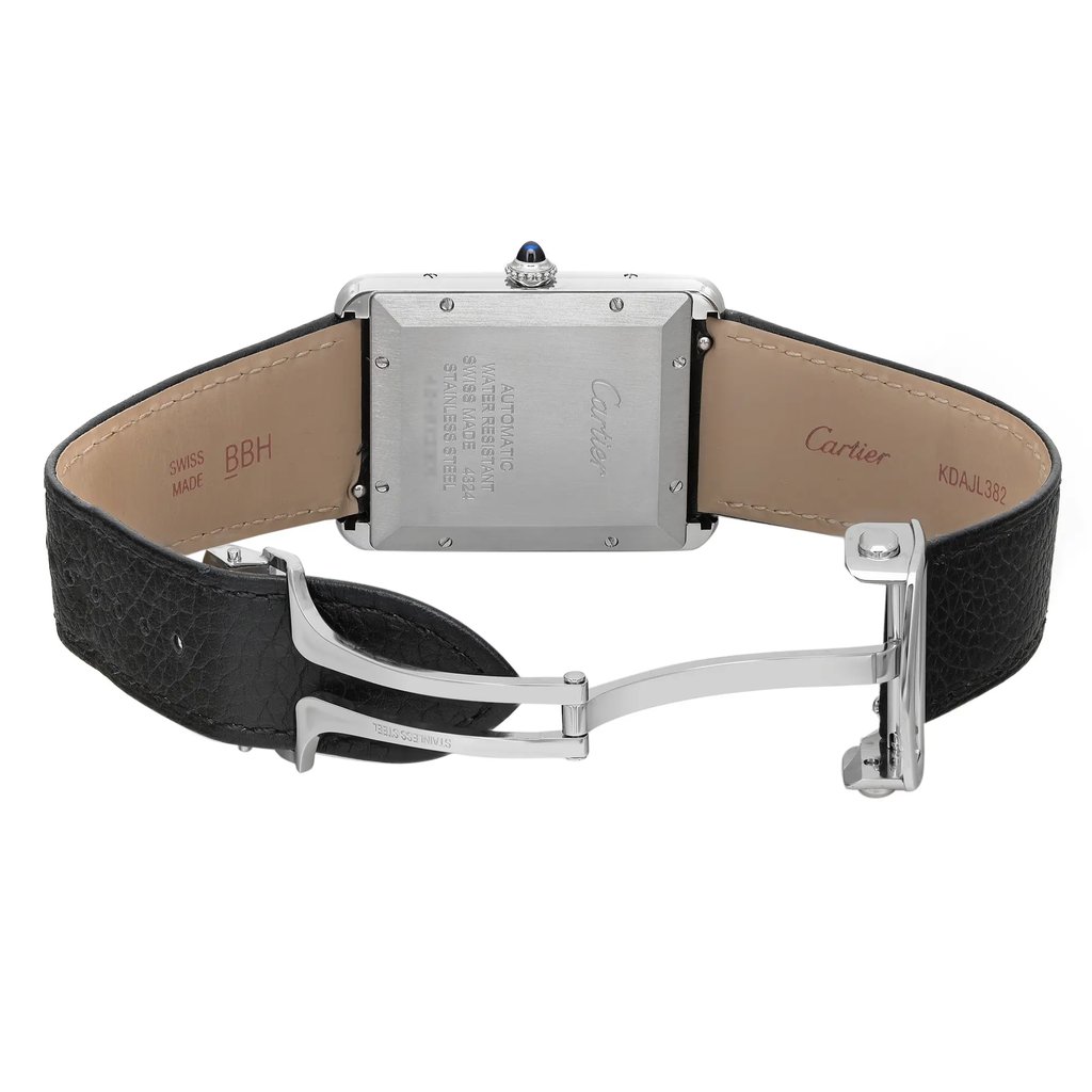 An image of a men's Cartier wristwatch, shown from the back with an open deployant clasp. The stainless steel screwback case is rectangular and positioned centrally in the frame. leather band is visible with a textured black material on the exterior and a tan interior with the brand name 'Cartier' embossed. The watch is photographed at a slight angle, showcasing the side of the case and the clasp mechanism, and is taken from a medium distance allowing clear visibility of the watch's details. The watch may have minor blemishes due to store handling.