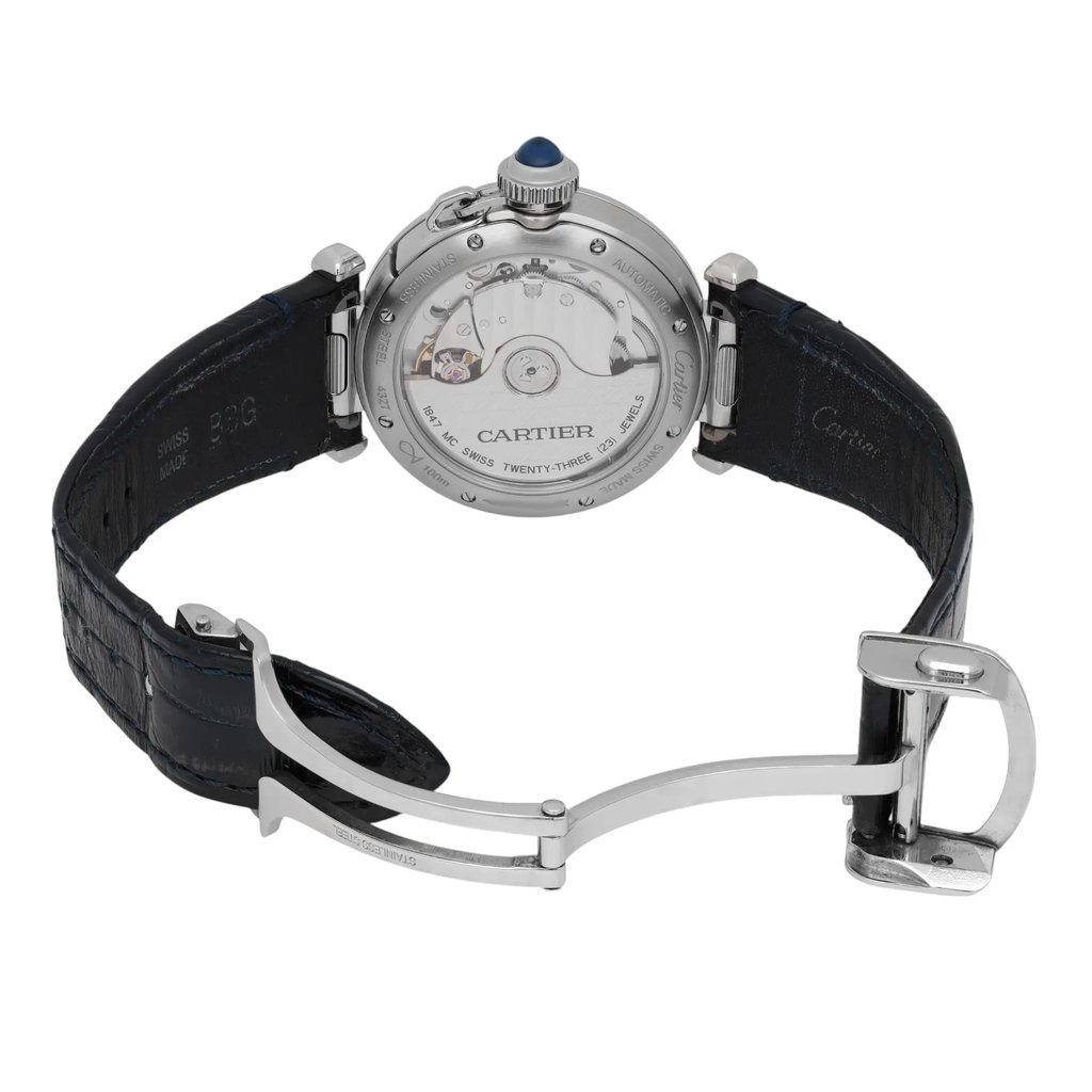 An image of a pre-owned Cartier men's wristwatch viewed from the back at a slight angle. The focus is on the watch's open clasp and its mechanical movement, with a visible blue cabochon on the crown. The watch is positioned centrally, with the strap extending outwards, showcasing the black leather texture and silver metal components.