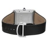 An image of a Cartier men's wristwatch, display model, viewed from the back showing the screwback case. The stainless steel case is rectangular with the brand's name engraved, and it is attached to a black leather band with a deployant clasp. The watch is positioned with the caseback facing up and the closure visible in the foreground, photographed from a top-down angle at close distance. The watch may have minor blemishes due to store handling.