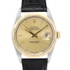 An image of a pre-owned men's Rolex Datejust 36mm 18K Gold Steel Champagne Dial Men's Watch 16233, captured from a straight-on angle at a close distance. The watch features a gold dial with a date indicator and luminous hands. The bezel is yellow gold, and the watch is complemented by a black leather strap. The brand name and model "Oyster Perpetual Datejust" are visible on the dial.