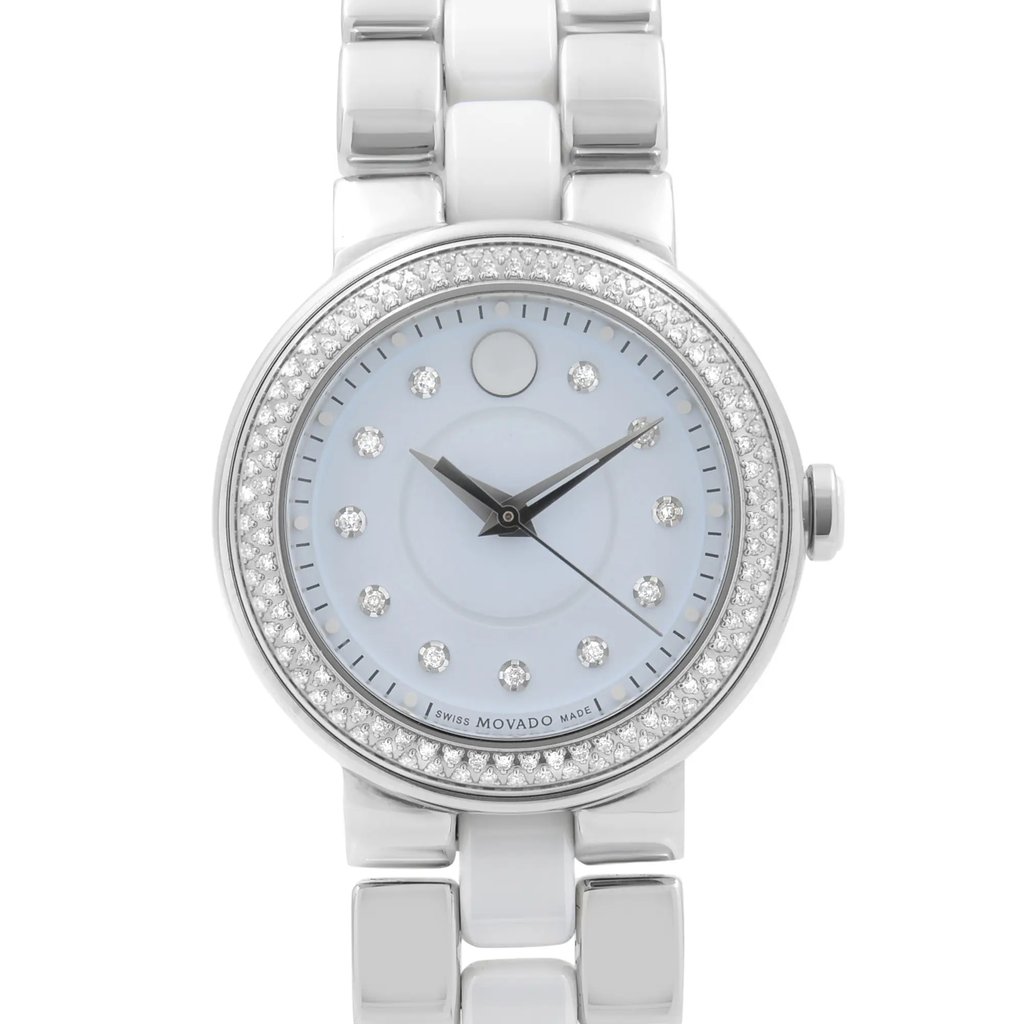 An image of a pre-owned wristwatch taken from a front close-up angle, highlighting the watch face. The watch features a silver bracelet and a round dial adorned with diamond hour markers and a diamond-set bezel. The hands are sleek and black, contrasting against the light-colored face.