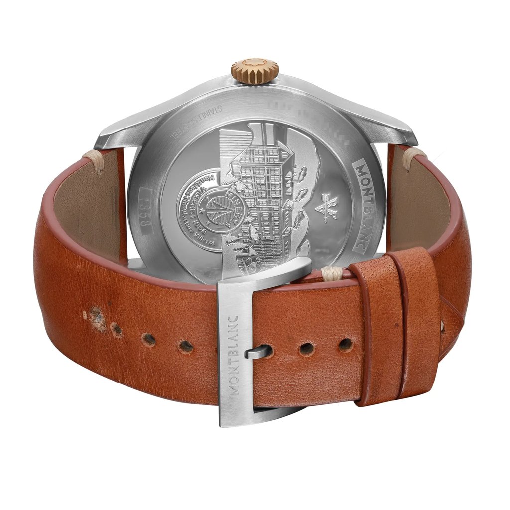 An image of a pre-owned Montblanc men's wristwatch, viewed from the back showing the solid stainless steel caseback with engraved details. The watch is positioned at a slight angle, with the top part tilting away from the viewer, providing a clear view of the back and the leather band. The round case is attached to a brown leather strap with visible wear and damage near the adjustment holes, particularly around the third hole from the top. The buckle closure is in the foreground, securely fastened with the Montblanc logo visible on the metal clasp. The photo is taken from a close distance, highlighting the textures and condition of the watch components.