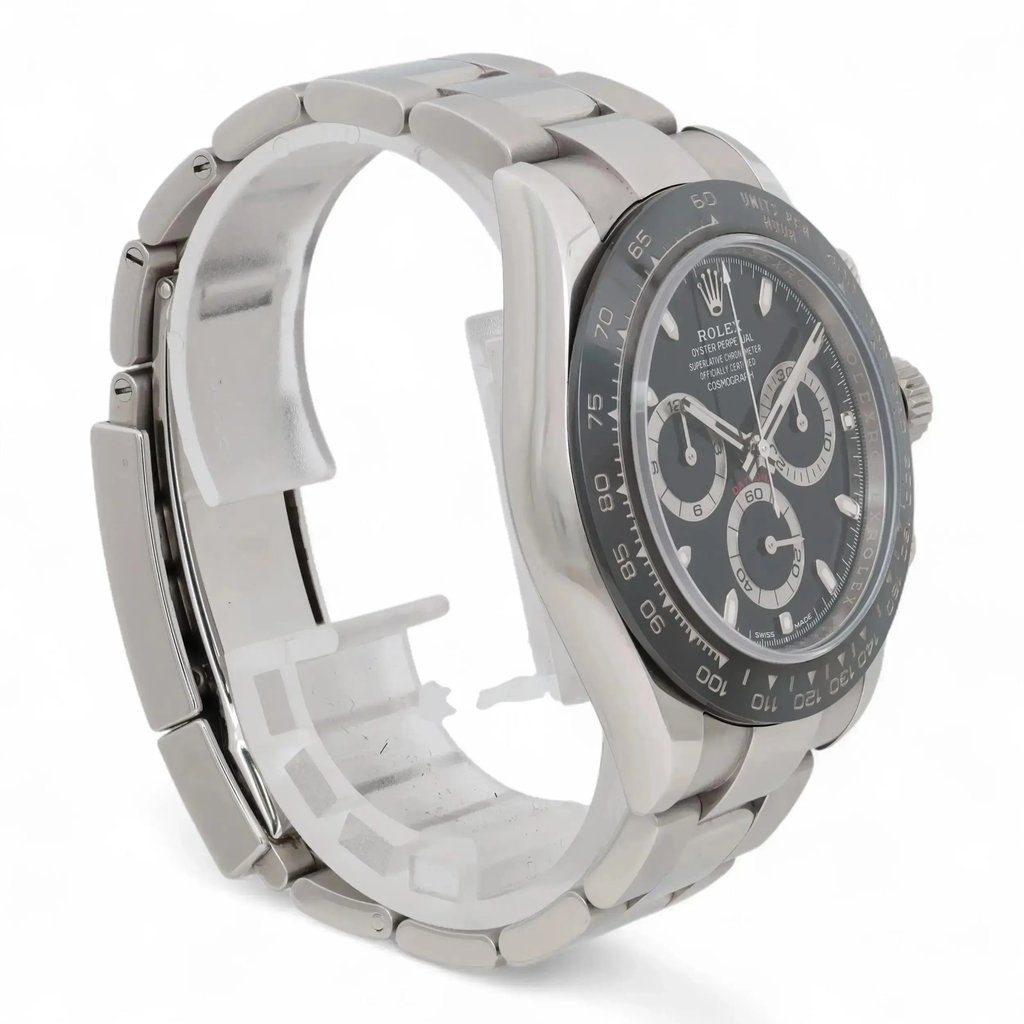 An image of a pre-owned men's Rolex wristwatch, positioned at a slight angle showing a side view of the watch face and bracelet. The watch features a chronograph, luminous hands, and a small seconds subdial. The bracelet and case are made of metal, and the watch face is a dark color with contrasting subdials, viewed from a medium distance.