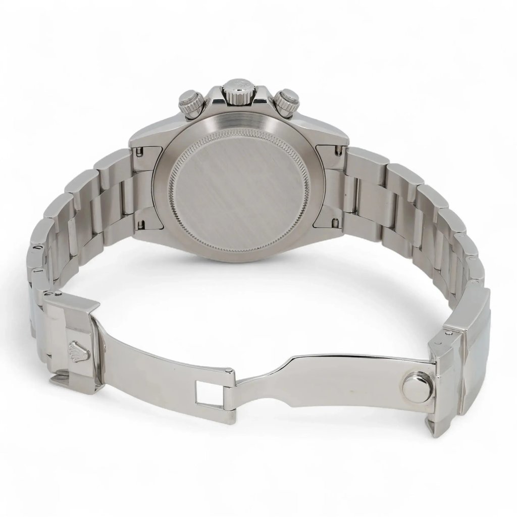 An image of a pre-owned men's Rolex wristwatch shown from the back. The watch is positioned upright, displaying its stainless steel case and bracelet. The angle is slightly elevated, capturing the closed clasp and the chronograph buttons on the side. The distance is close-up, highlighting the brushed metal finish and detailing on the bracelet links.