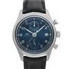 An image of a pre-owned IWC men's wristwatch with a pilot/aviator style, positioned frontally for a close-up view of the watch face. The watch features a round stainless steel case, a sunburst blue dial with a gray bezel, and Arabic numeral indices. It has a 12-hour dial displaying excellent condition and a date window at the 3 o'clock position. Attached is a black leather band and the overall angle of the shot is directly centered on the watch face, providing a clear and detailed view of the timepiece. The watch is pre-owned and in excellent condition.