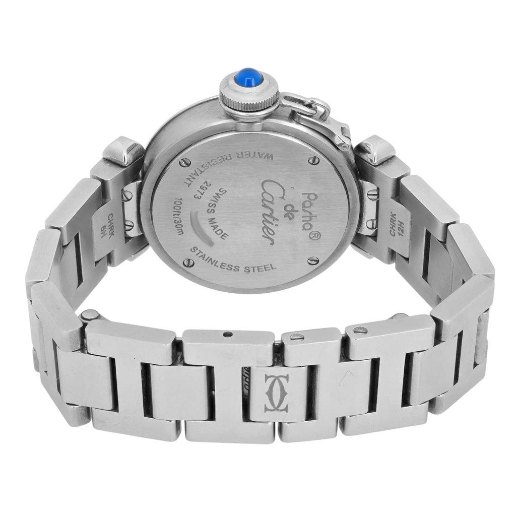 An image of a pre-owned women's Cartier wristwatch viewed from the back. The watch is positioned at a slight angle, showing the stainless steel case back and part of the bracelet. The watch is placed at a moderate distance, allowing a clear view of the engraved details on the back, including the brand name and specifications. The bracelet is partially visible, highlighting its polished links and the deployment clasp.