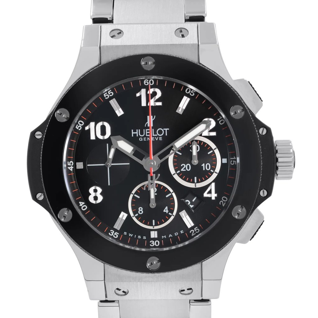 An image of a pre-owned wristwatch captured in a front close-up shot. The watch features a black dial with white and red accents, including hour markers, hands, and three sub-dials. The bezel is secured with screws, and the crown is positioned on the right. The stainless steel bracelet is partially visible, showcasing its polished surface.