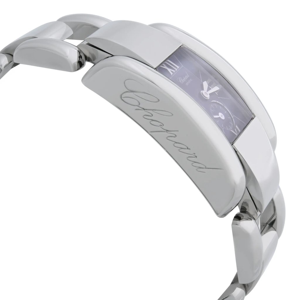 An image of a pre-owned wristwatch viewed from the side profile, opposite the crown, showcasing the sleek, polished metal band and a rectangular face. The watch is positioned at a slight angle, highlighting the engraved brand name on the side. The close-up perspective emphasizes the watch's elegant design and craftsmanship.