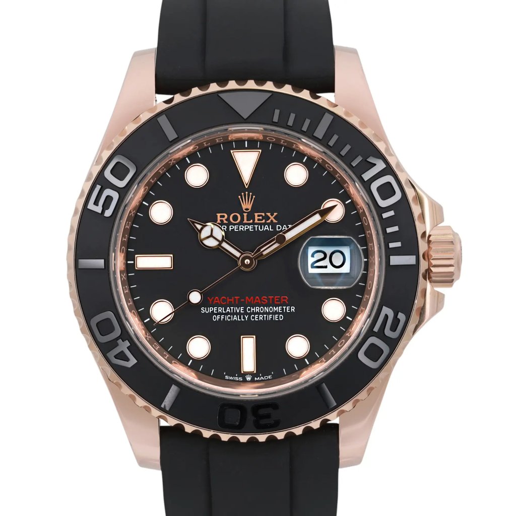 An image of a pre-owned men's Rolex wristwatch viewed from the front at a close angle. The watch features a black dial with luminous hands and a date indicator on the right side. The bezel is marked with large numerals, and the watch is fitted with a black strap.