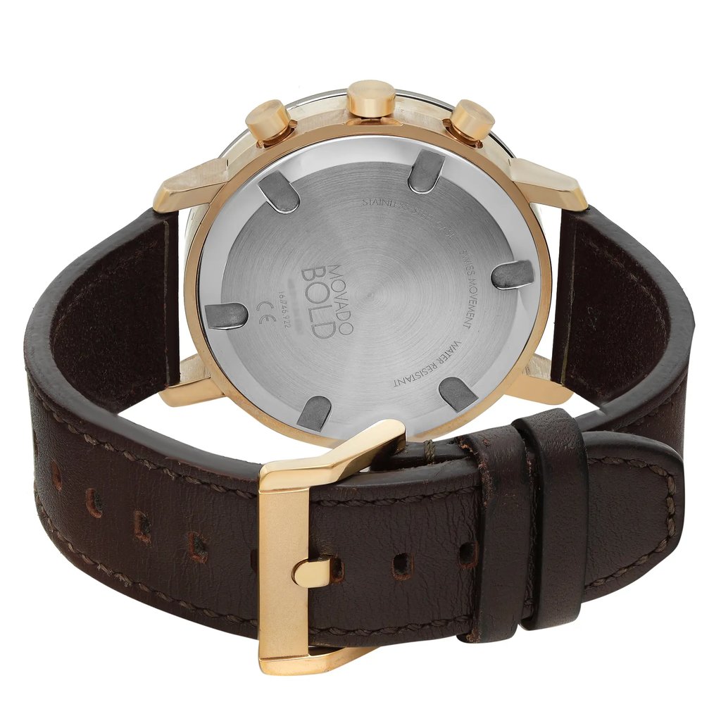 An image of a pre-owned wristwatch showcasing the back view. The watch features a round stainless steel case with a gold-tone finish and three pushers. It is positioned at a slight angle, allowing a clear view of the engraved markings on the case back. The dark brown leather strap is visible, with a gold-tone buckle clasp fastened. The image is taken from a close distance, highlighting the details of the clasp and case back.