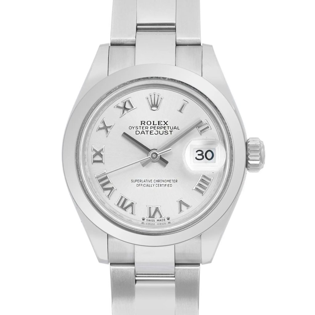 An image of a pre-owned wristwatch shown in a front close-up shot. The watch face features Roman numerals, a date display at the 3 o'clock position, and a silver-tone finish. The metal bracelet is partially visible, emphasizing the watch's elegant design.