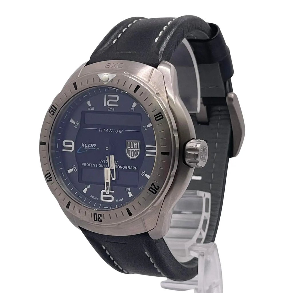 An image of a Wristwatch by Luminox. This Pre Owned item is designed for Men, featuring a Casual,Classic,Dress/Formal,Military,Sport style. It has a Quartz movement and an Analog & Digital display with a Black dial color. The indices include 12-Hour Dial,24-Hour Dial,Arabic Numerals,Baton Indexes. The band is made of Leather and the case is made of Titanium. The watch has a Round shape with a case size of 46 mm and a case thickness of 14 mm.