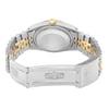An image of a pre-owned wristwatch shown from the back view with an open clasp. The watch features a two-tone metal link bracelet, combining silver and gold hues. The focus is on the case back and bracelet, captured from a close distance at a slightly elevated angle, highlighting the intricate design of the clasp and links.