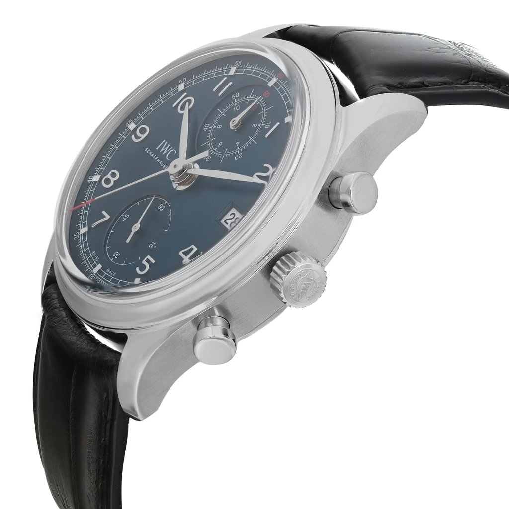 An image of a pre-owned IWC men's pilot/aviator style wristwatch, presented in a side profile view with the crown and two pushers visible. The watch features a round stainless steel case, a sunburst blue dial with gray markings, and a gray bezel. It has a black leather strap. The photo is taken at a close distance, emphasizing the watch's side profile and the details of the crown and pushers. The watch is pre-owned and in excellent condition.