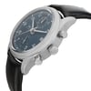 An image of a pre-owned IWC men's pilot/aviator style wristwatch, presented in a side profile view with the crown and two pushers visible. The watch features a round stainless steel case, a sunburst blue dial with gray markings, and a gray bezel. It has a black leather strap. The photo is taken at a close distance, emphasizing the watch's side profile and the details of the crown and pushers. The watch is pre-owned and in excellent condition.
