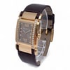 An image of a pre-owned Patek Philippe women's wristwatch positioned at a slight angle, showcasing its elegant rectangular face. The watch features a rose gold case adorned with two rows of small diamonds on each side. The dial is brown with Roman numerals at the twelve and six o'clock positions, complemented by diamond hour markers. The watch is attached to a dark brown leather strap. The image is taken from a close distance, highlighting the watch's luxurious details.