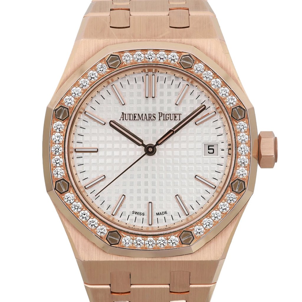 An image of a pre-owned men's luxury wristwatch by Audemars Piguet, captured in a front close-up shot focusing on the watch face. The octagon-shaped case is made of rose gold, matching the band material. The dial is silver with a "tapisserie" pattern, featuring stick indexes and a date function. The rose gold bezel is adorned with diamonds, and the watch includes luminous hands. The condition is classified as good.