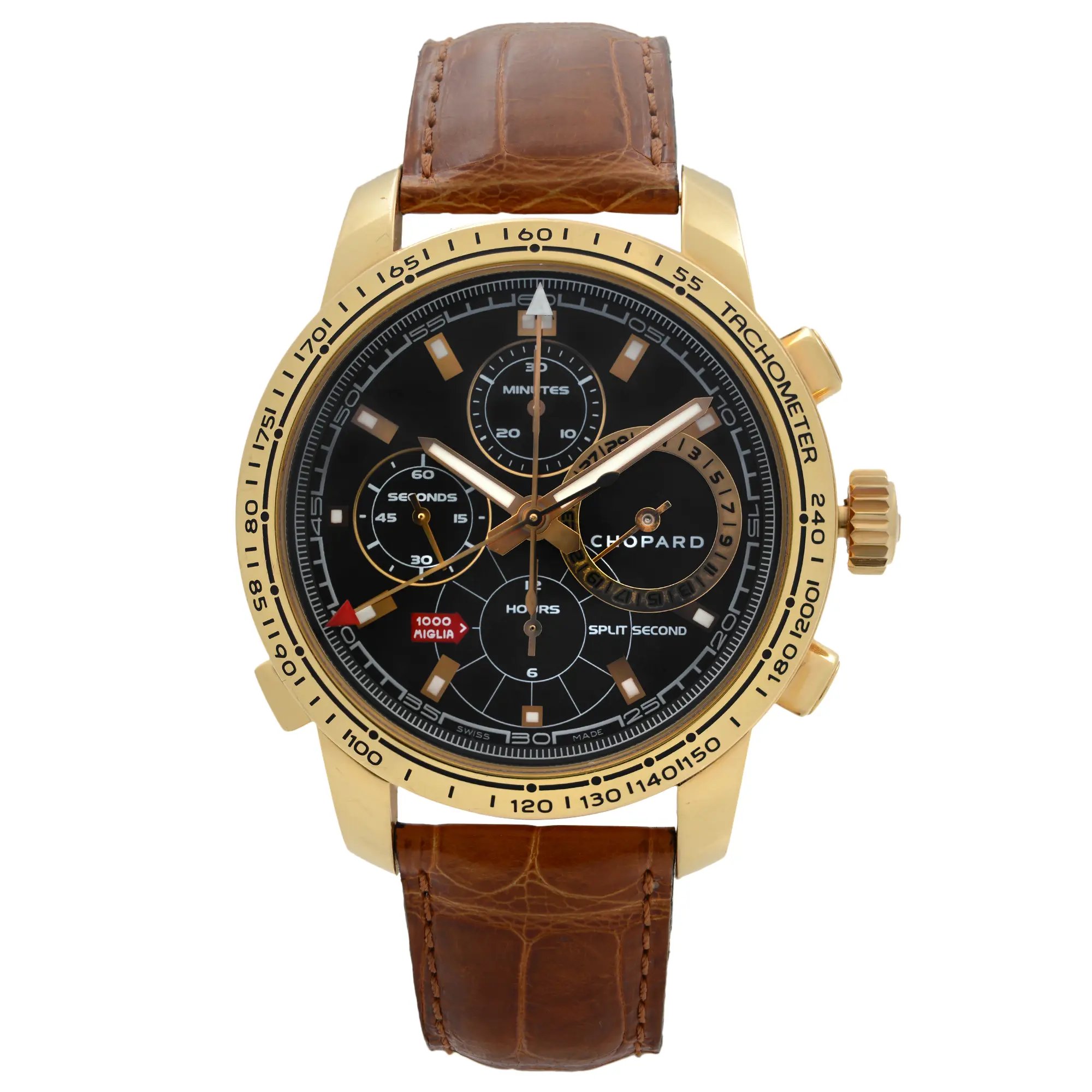 The image presents a close-up front view of a pre-owned men's Chopard Mille Miglia Split Second Chronograph Limited Edition Watch (16/1261). This wristwatch features an 18k gold case, a black dial with chronograph functions, a date indicator, luminous hands, and a small seconds subdial. It is paired with a brown leather deployment strap and a tachymeter scale on the bezel. Please note, the leather strap shows signs of wear and there are stains on the inside of the strap. 