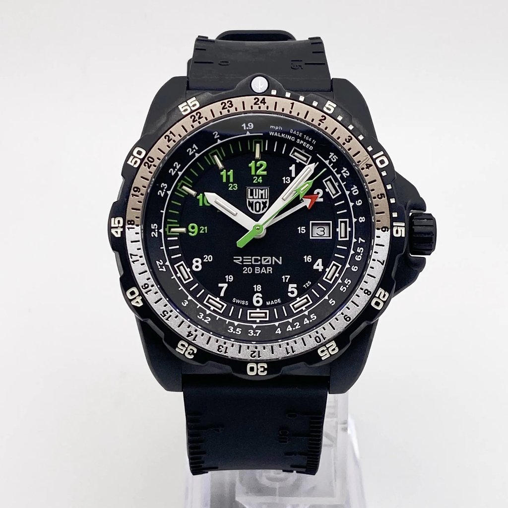 An image of a Wristwatch by Luminox. This Pre Owned item is designed for Men, featuring a Military style. It has a Quartz movement and an Analog display with a Black dial color. The indices include 12-Hour Dial,24-Hour Dial,Arabic Numerals. The band is made of Rubber and the case is made of Carbon. The watch has a Round shape with a case size of 46 mm and a case thickness of 14 mm.