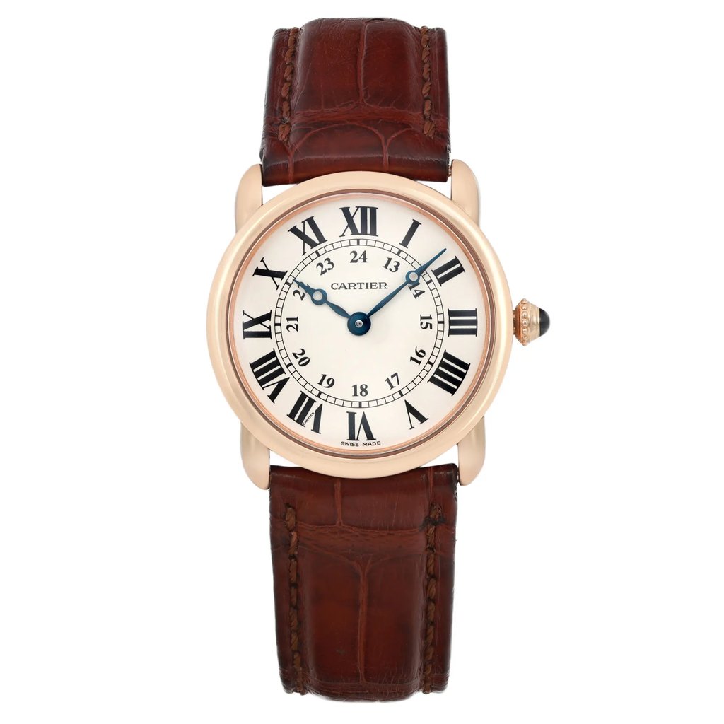 An image of a pre-owned wristwatch viewed from the front in a full frontal position. The watch features a round face with Roman numerals, blue hands, and a brown leather strap. The crown is adorned with a small blue gemstone. The photo is taken at a close distance, showcasing the details of the watch's design and condition.