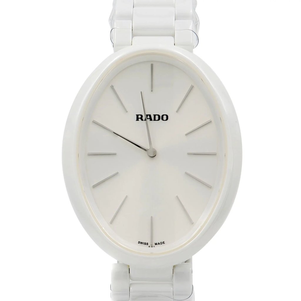 An image of a display model wristwatch captured in a front close-up shot, focusing on the watch face. The watch features a minimalist design with a white dial, thin silver hour markers, and matching hands. The brand logo is positioned near the top of the dial. The watch is centered in the frame, providing a clear view of its elegant and modern design.