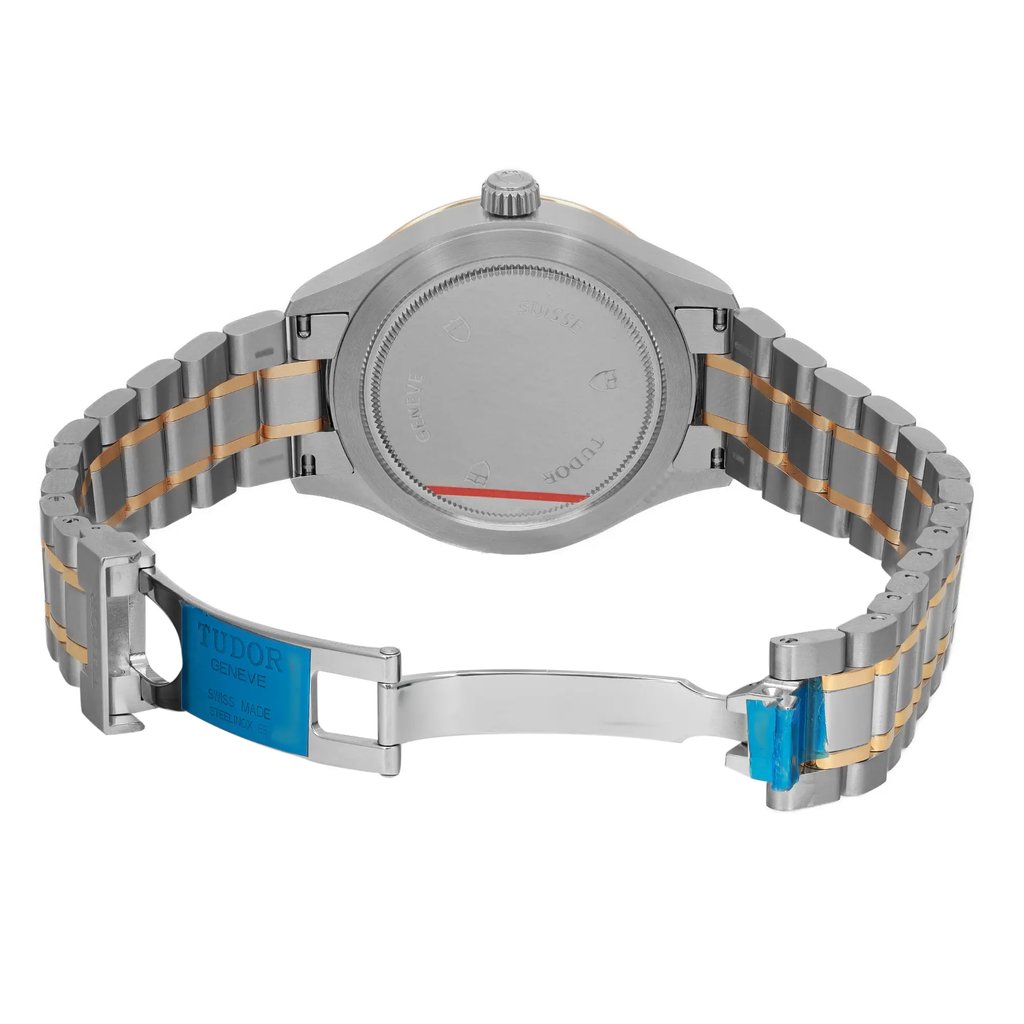 An image of a wristwatch taken from the back view with the clasp open. The watch is positioned centrally, showcasing its unworn condition. The angle captures the full length of the stainless steel and gold-tone bracelet from a close distance, highlighting the brand name on the clasp.