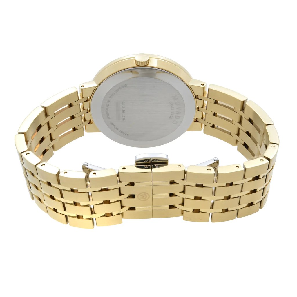An image of a gold-tone wristwatch showcasing its back view. The watch is positioned upright with a focus on the closed clasp. The angle captures the intricate design of the metal bracelet links, and it is taken from a close distance to emphasize detail. The watch is labeled as new but with defects.
