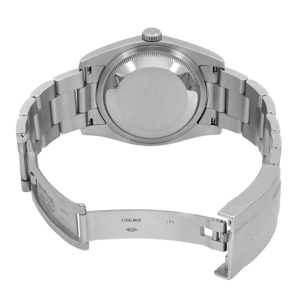 An image of a pre-owned wristwatch viewed from the back, showcasing the open clasp. The photo is taken from a slightly elevated angle, focusing on the back of the watch case and open metal bracelet. The watch is positioned centrally in the frame, with the clasp open to reveal engraved markings on the inner side.